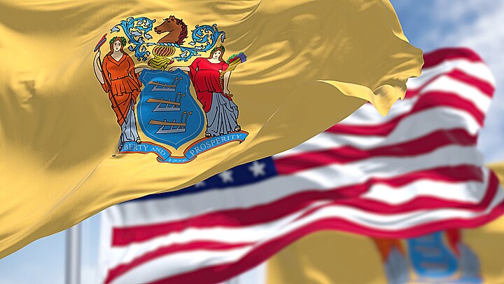 Ner Jersey state flag waving alongside the American flag