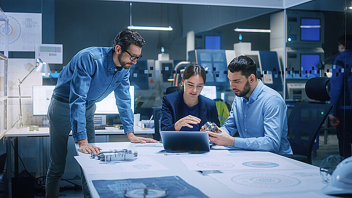 Professionals working in an office with technology