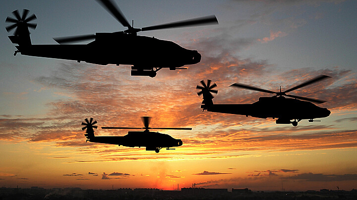 U.S. Army Blackhawk helicopters fly over Iraq at sunset