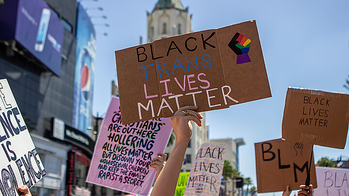 Manifestante con un cartel de Black Trans Lives Matter en la marcha