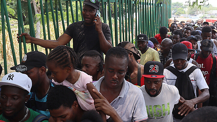 Migrants wait in line for immigration processing in Tapachula, Mexico