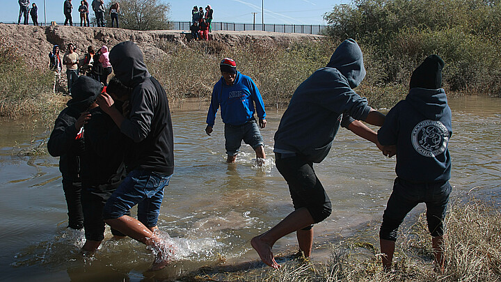 Juarez, Chihuahua, Mexico, a group of Guatemalan migrants crosses the Rio Grande