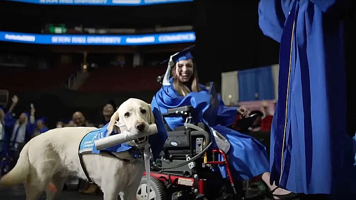 Justin, the service dog for Grace Mariani, was presented with a diploma