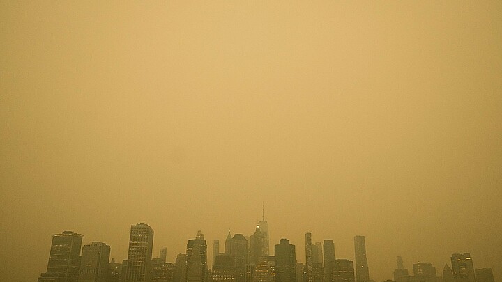 An orange haze settles over Manhattan amid haze and smoke coming to NYC from Canada