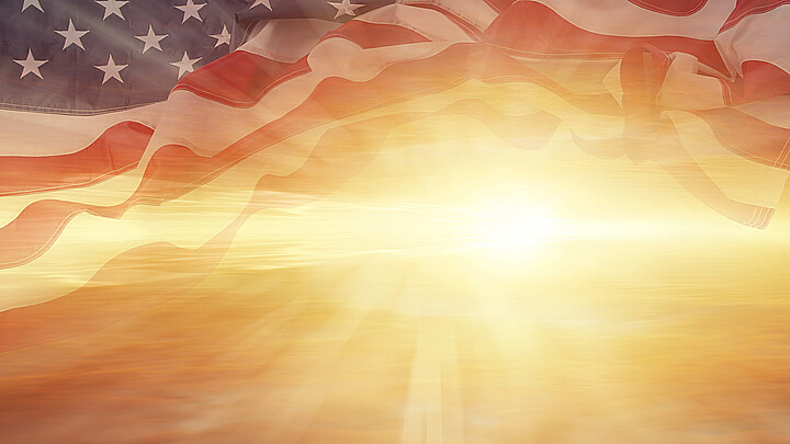 Sun shining through American flag