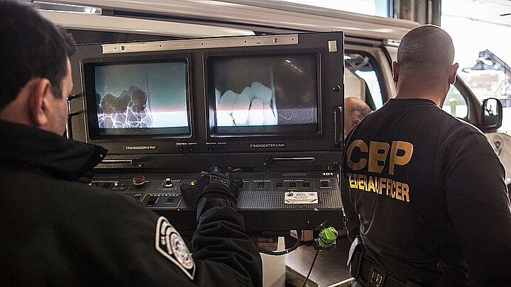 Border Patrol officers use X-Ray scanner machine at crossing point