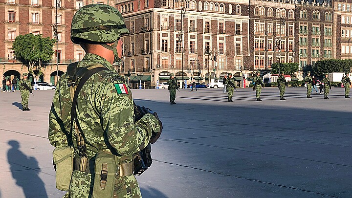 Mexican soldier stands for the raising of the national flag in the Zócalo square in Mexico City