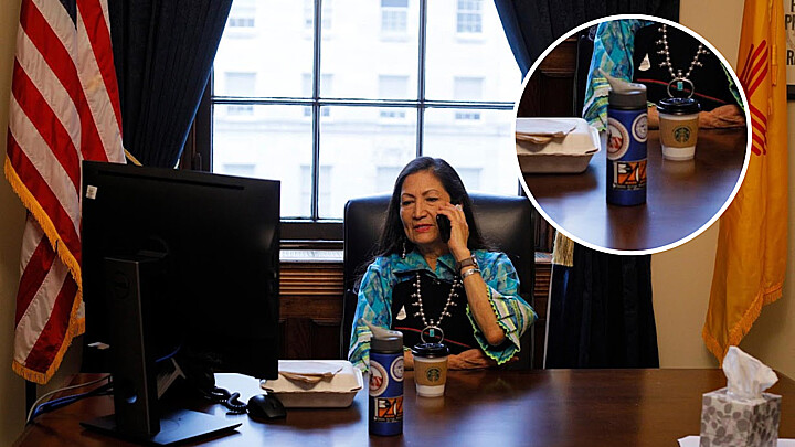 Haaland works in her office at the U.S. Capitol before being sworn in. In the table a bottle can be seen with a Pueblo Action Alliance sticker