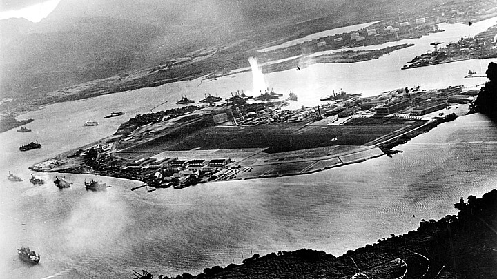 Photograph taken from a Japanese plane during the torpedo attack on ships moored on both sides of Ford Island shortly after the beginning of the Pearl Harbor attack