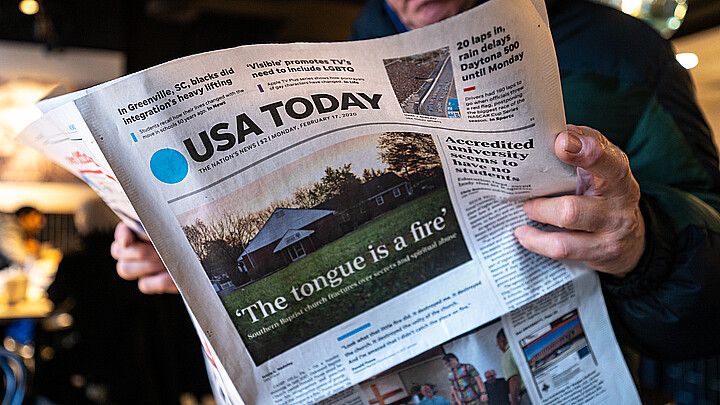 Man reading a USA Today newspaper stock photo