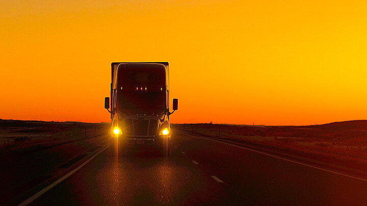 Stock photo of tractor trailer truck at sunset