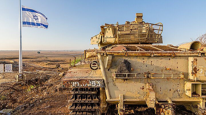 Israeli flag flying beside a decommissioned Israeli Centurion tank used during the Yom Kippur War at Tel Saki on the Golan Heights in Israel