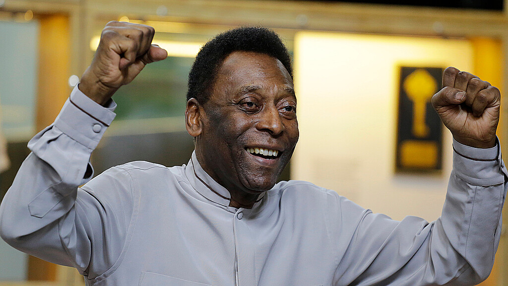 Former soccer great Edson Arantes do Nascimento, known as Pele, pose for photos during the inauguration of the Pele Museum