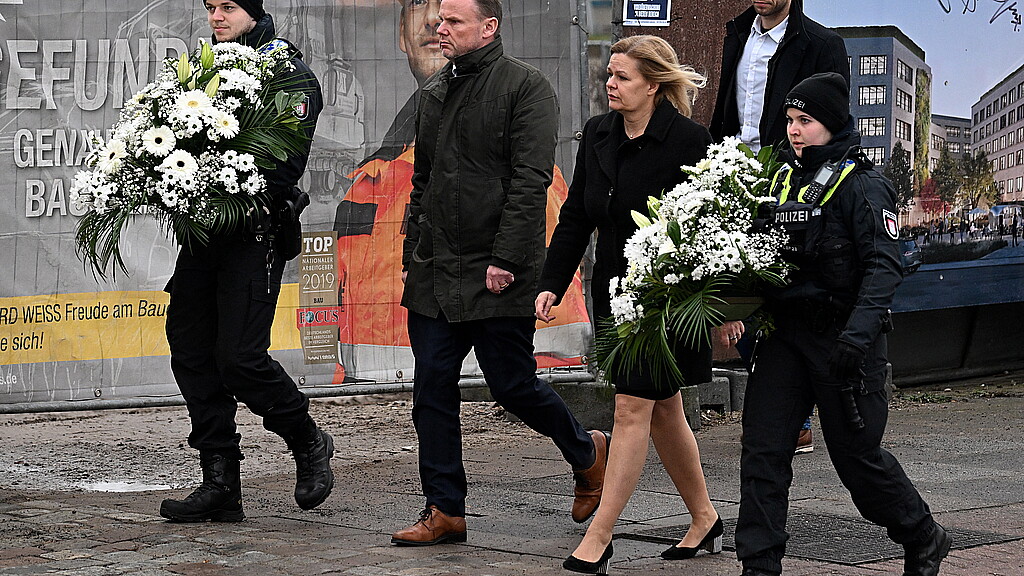Hamburg Interior Senator Andy Grote (2-L) and German Interior minister Nancy Faeser (C) visit the scene of a shooting in Hamburg, Germany, 10 March 2023.