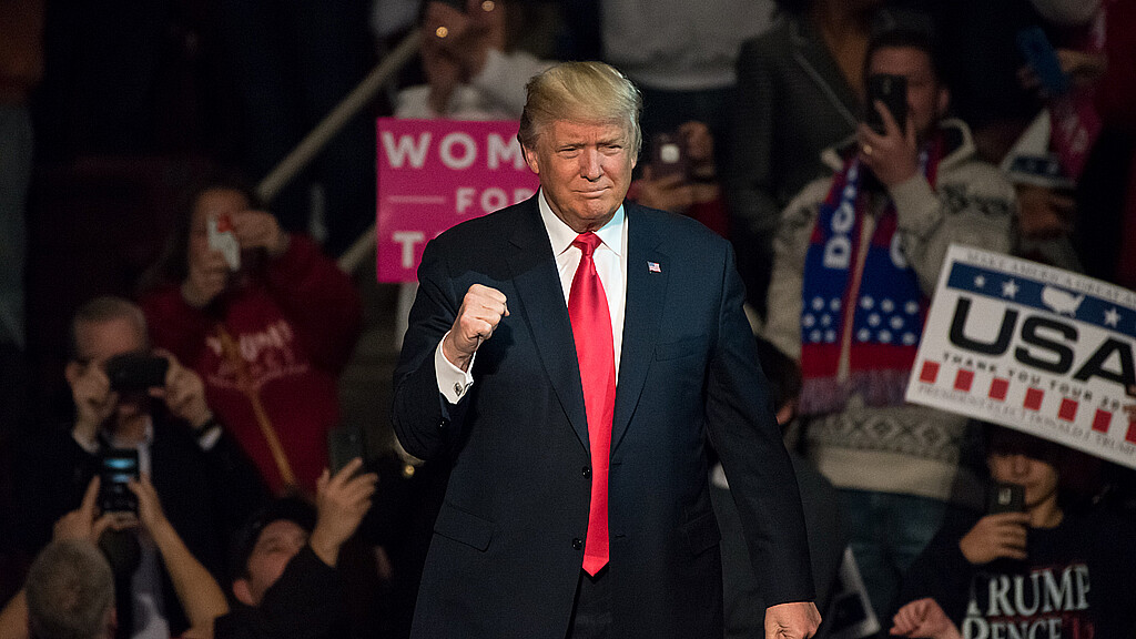 President-Elect Donald Trump gives a "Fist Pump" to the crowd as he arrives on stage to deliver a speech at a "Thank You" Tour rally at the Giant Center.