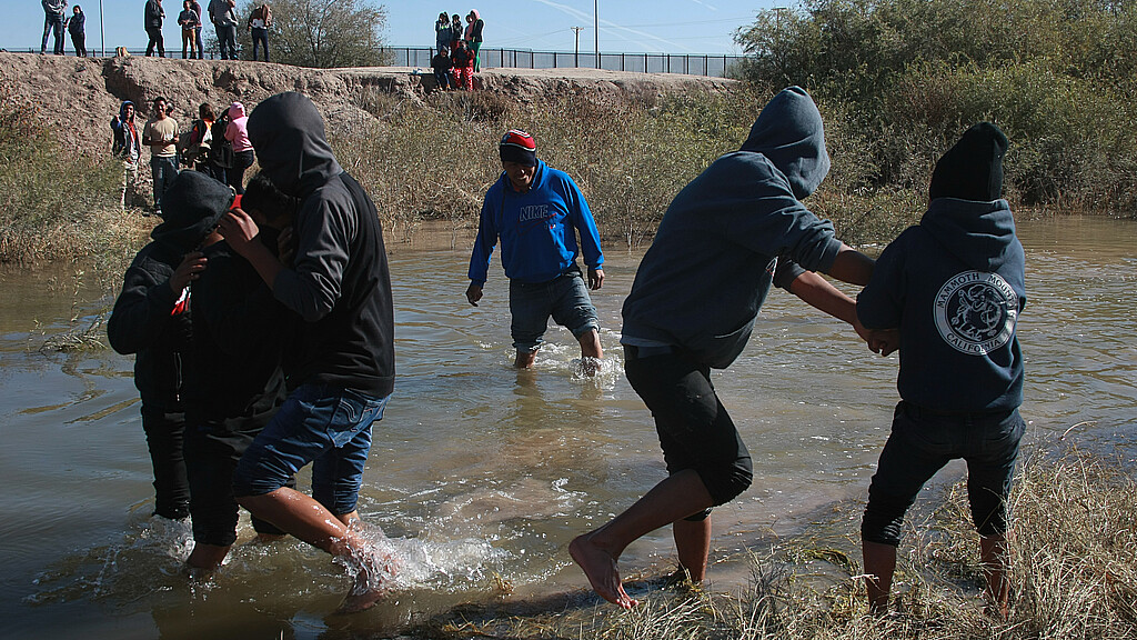 Juarez, Chihuahua, Mexico, a group of Guatemalan migrants crosses the Rio Grande