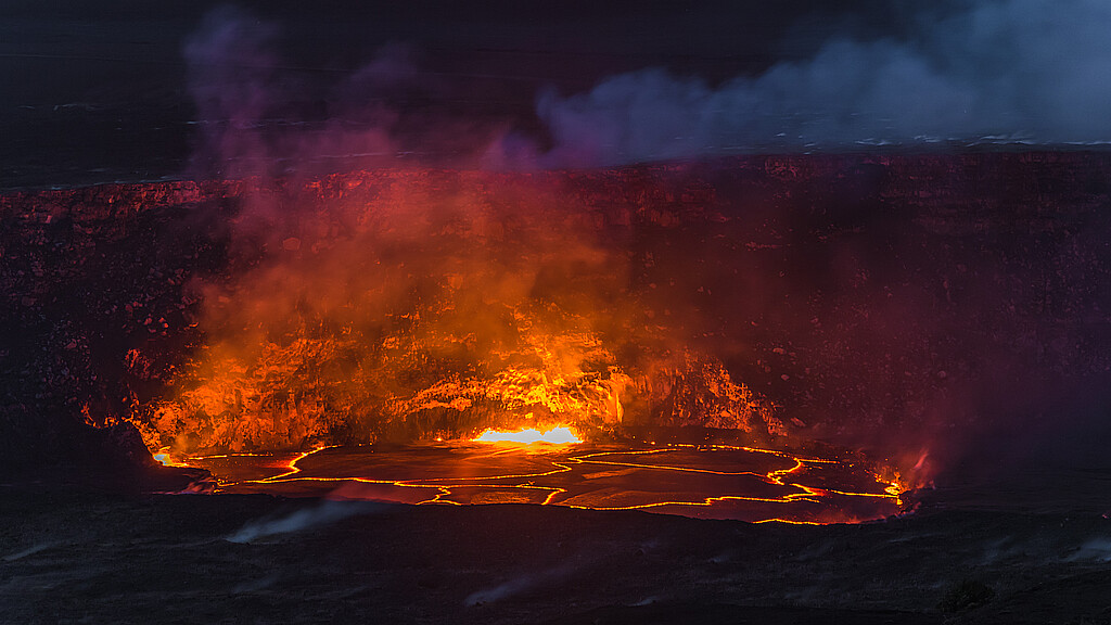 Volcano, Hawaii - April 22, 2018: Kilauea Volcano's summit lava lake overflows onto Halemaumau Crater in Hawaii Volcanoes National Park on Hawaii's Big Island