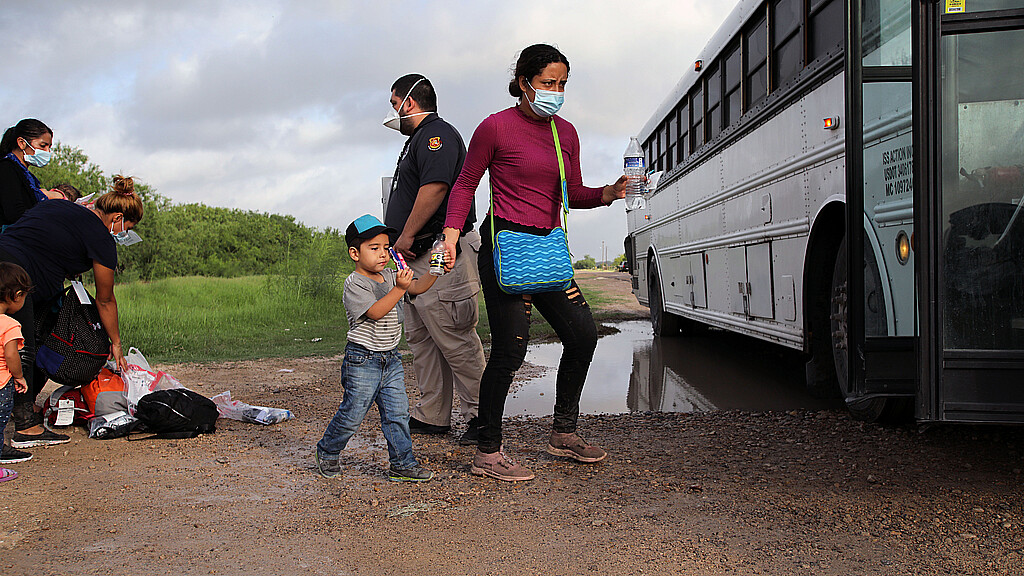  Migrants boarding bus in Texas