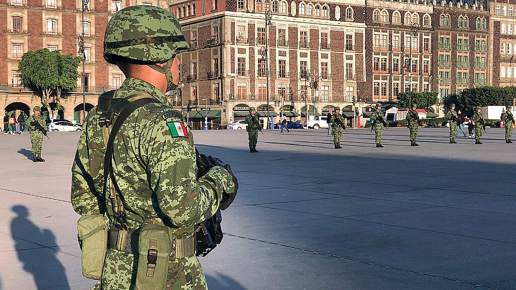 Mexican soldier stands for the raising of the national flag in the Zócalo square in Mexico City