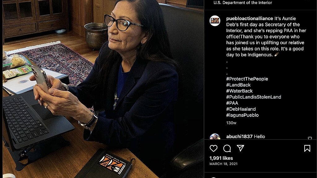 A photo posted on Instagram shows Deb Haaland with a PAA logo affixed to a binder