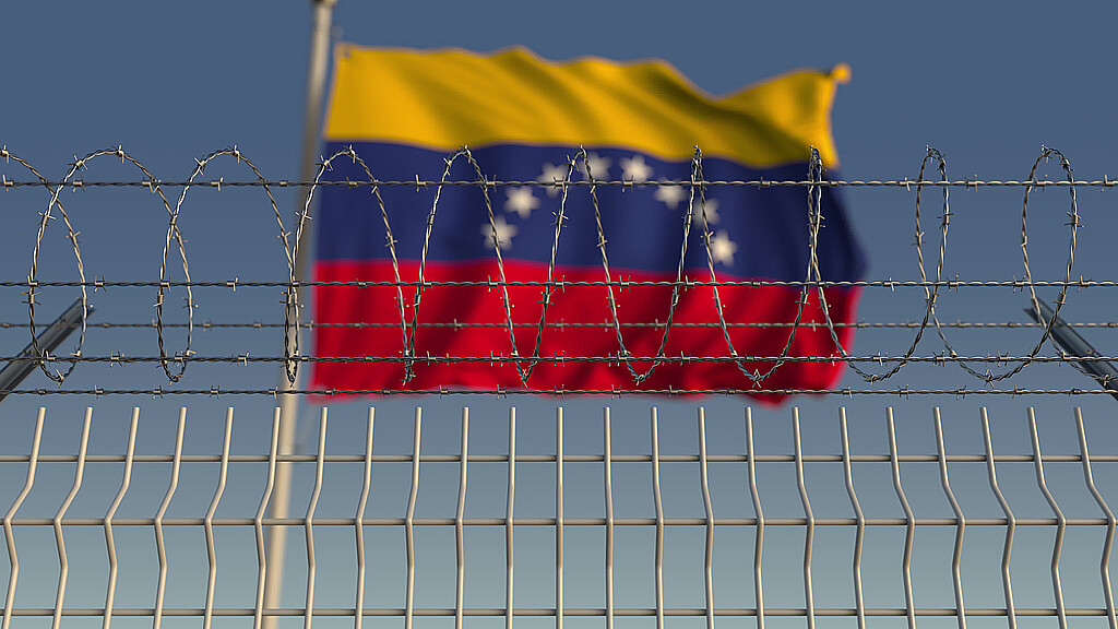 Image of Venezuelan flag above barbed wire