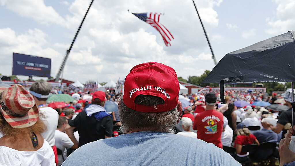 Supporters watch former President Donald Trump rushed off stage after shots fired