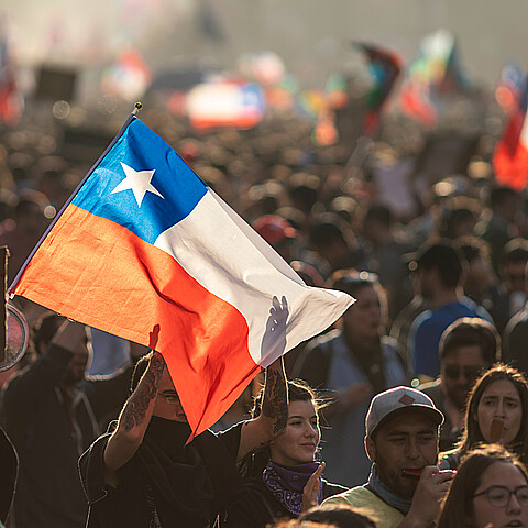 Santiago de Chile Chile 29 October 2019 People crowds protesting at Santiago de Chile streets in Plaza de Italia during latest Chile protests and general strike. Police repeal the crowd with tear gas