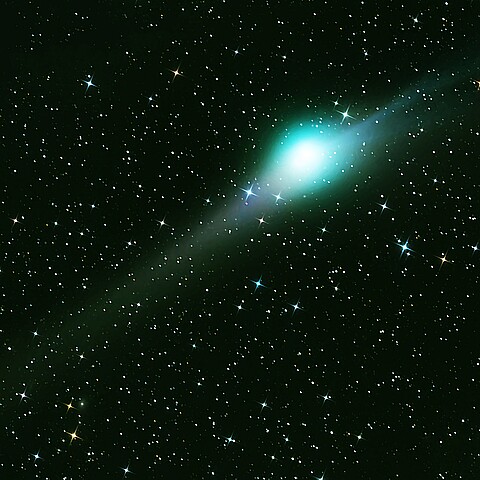 Green comet in dark space. Elements of this image furnished by NASA. 