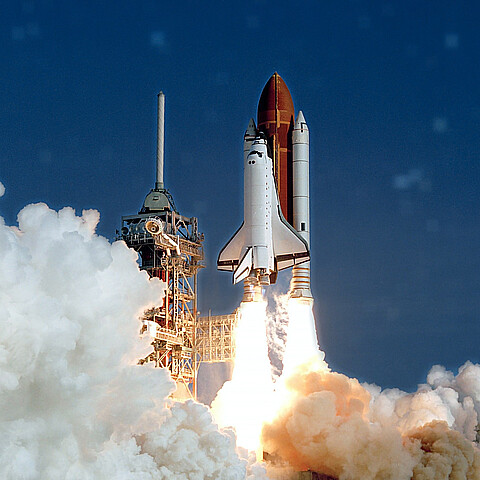 The launch of the NASA Space Shuttle. With fire and smoke. Against the background of the starry sky. Elements of this image were furnished by NASA.