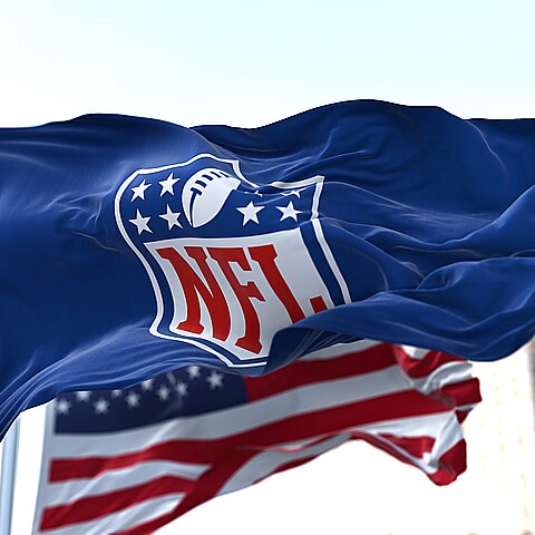 NFL flag waving by the American flag