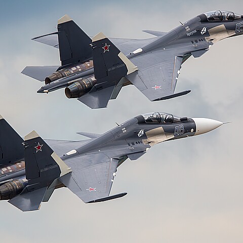 A pair of Sukhoi SU-30 SM jet fighters are performing a demonstration flight in 2021