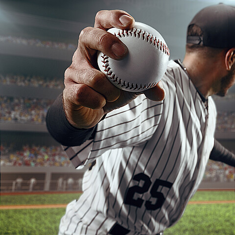 Baseball player throws the ball on professional baseball stadium