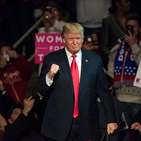 President-Elect Donald Trump gives a "Fist Pump" to the crowd as he arrives on stage to deliver a speech at a "Thank You" Tour rally at the Giant Center.