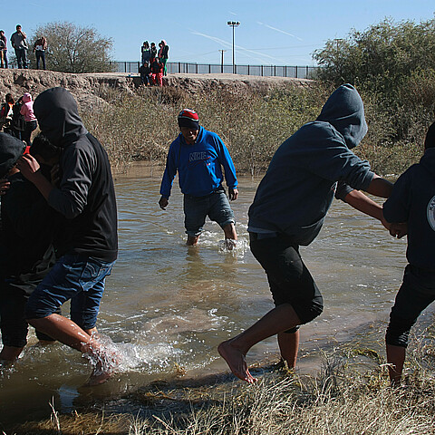 Juarez, Chihuahua, Mexico, a group of Guatemalan migrants crosses the Rio Grande