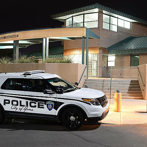 Yuma, Arizona Police Department with police vehicle at night