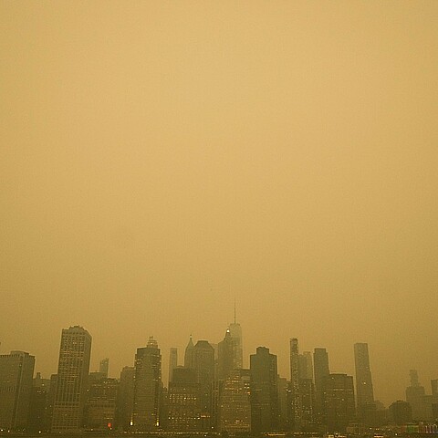 An orange haze settles over Manhattan amid haze and smoke coming to NYC from Canada