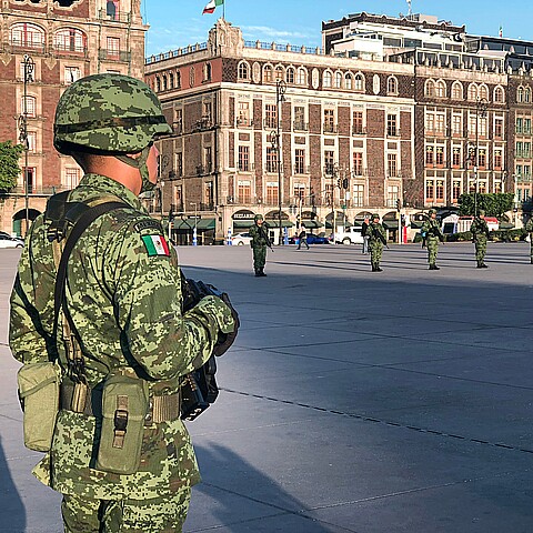 Mexican soldier stands for the raising of the national flag in the Zócalo square in Mexico City