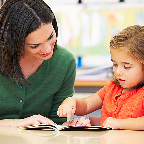 A mother reads with her child