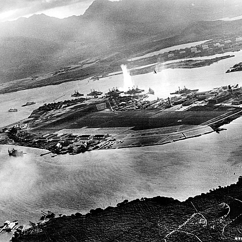 Photograph taken from a Japanese plane during the torpedo attack on ships moored on both sides of Ford Island shortly after the beginning of the Pearl Harbor attack