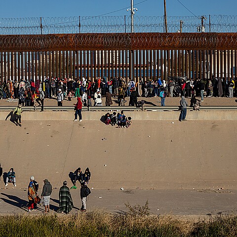 Hundreds of migrants wait in front of the wall to be able to turn themselves in to the border patrol in American territory, to request humanitarian asylum.