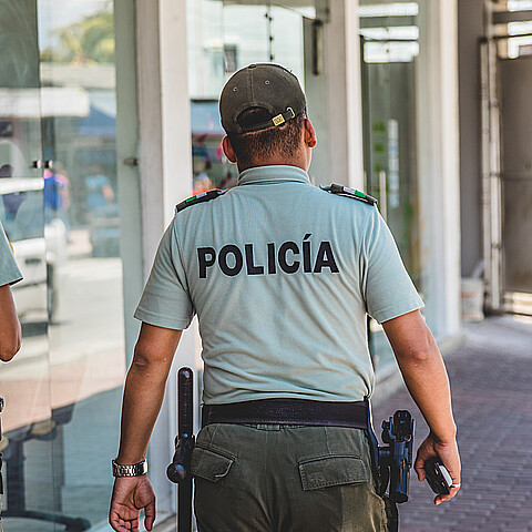 Colombian police officers patrol a street circa 2017