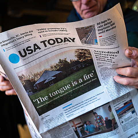 Man reading a USA Today newspaper stock photo