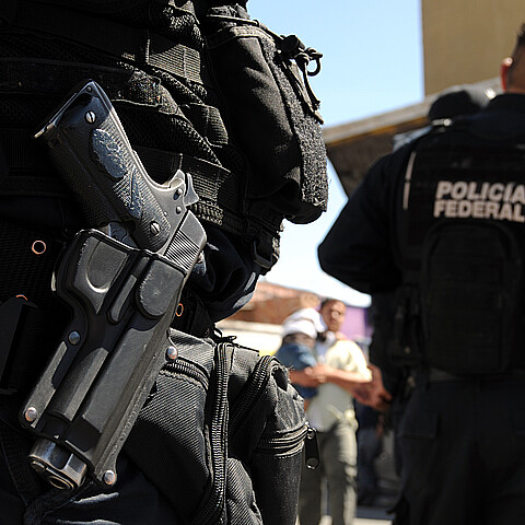 Closeup of a handgun of Mexican federal police forces maintaining order in the violent border city of Ciudad Juarez