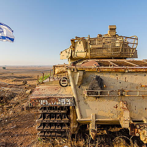 Israeli flag flying beside a decommissioned Israeli Centurion tank used during the Yom Kippur War at Tel Saki on the Golan Heights in Israel