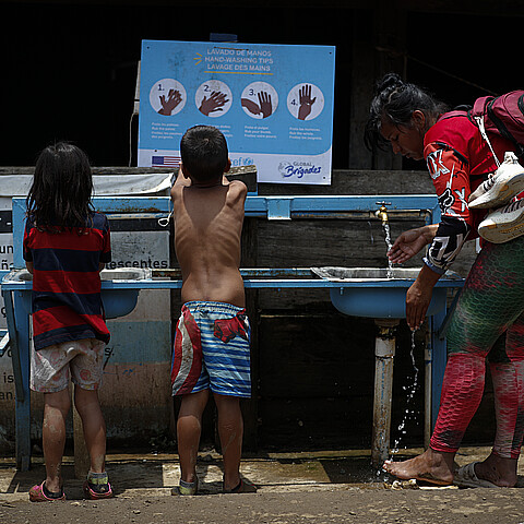 Migrant woman and two children after crossing the Darién jungle in Lajas Blancas (Panama) on May 3, 2024