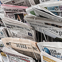 A London newspaper rack holding several international newspapers