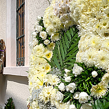 Corona de flores blancas en el exterior de una funeraria