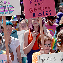 Seattle Pride parade showing teenagers holding signs 