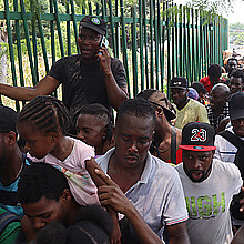 Migrants wait in line for immigration processing in Tapachula, Mexico