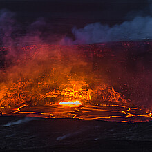 Volcano, Hawaii - April 22, 2018: Kilauea Volcano's summit lava lake overflows onto Halemaumau Crater in Hawaii Volcanoes National Park on Hawaii's Big Island